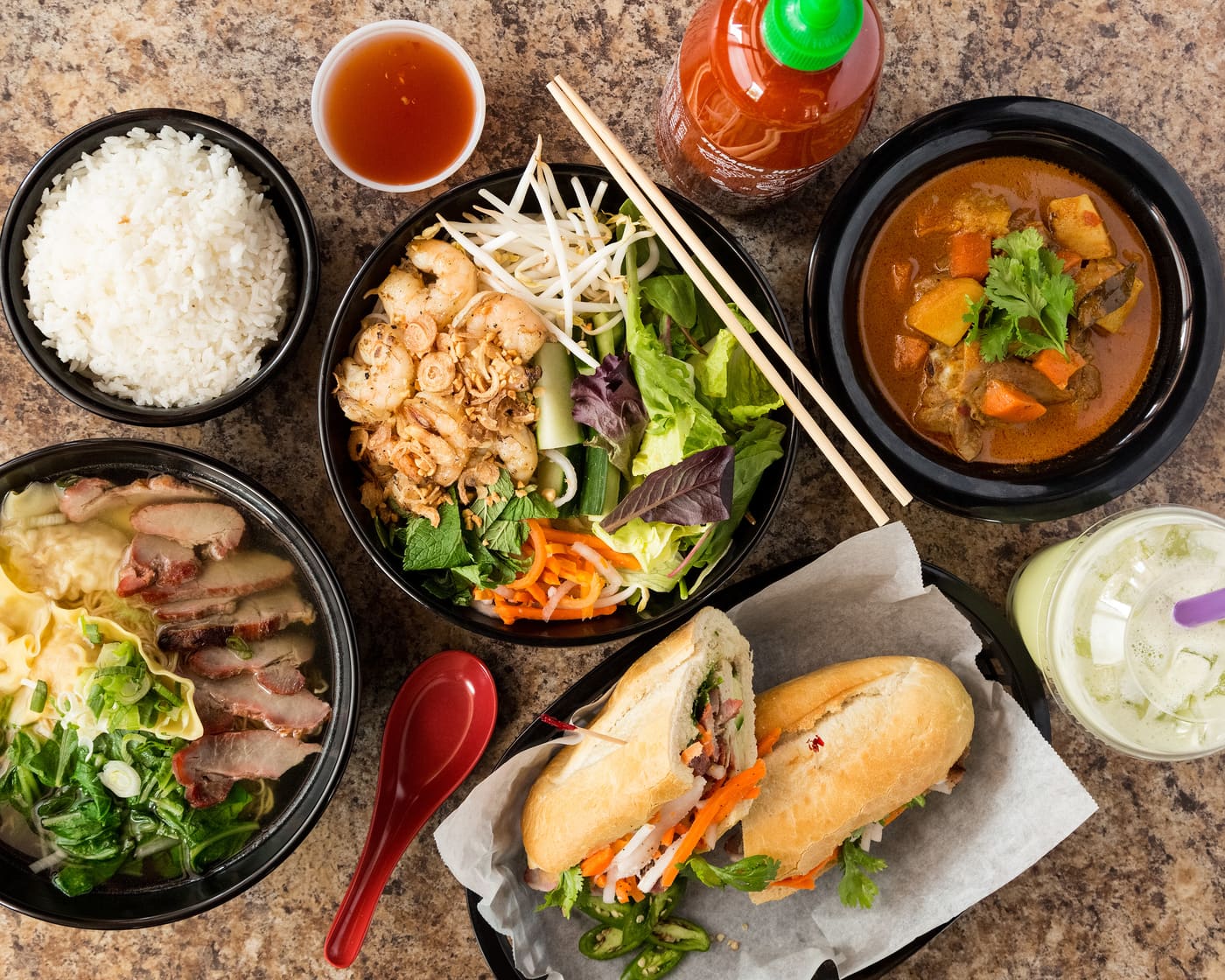 A 5-Spice spread: noodle soup, bún salad, bánh mì, curry, rice and a bubble tea